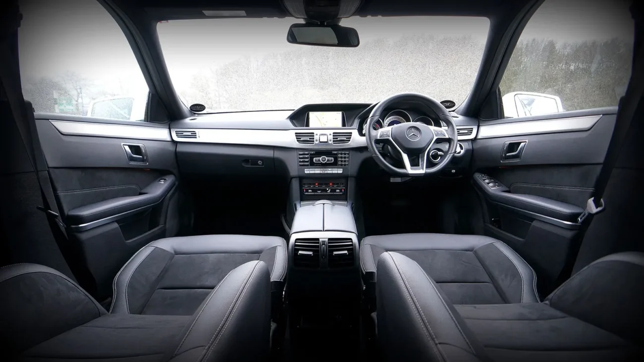Car interior with steering wheel and seats
