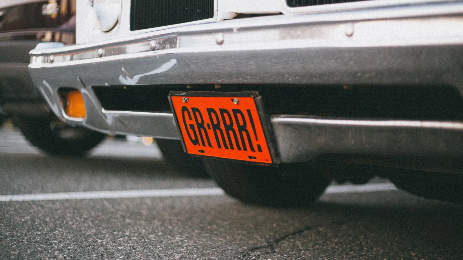 Close-up of a car number plate and bumper