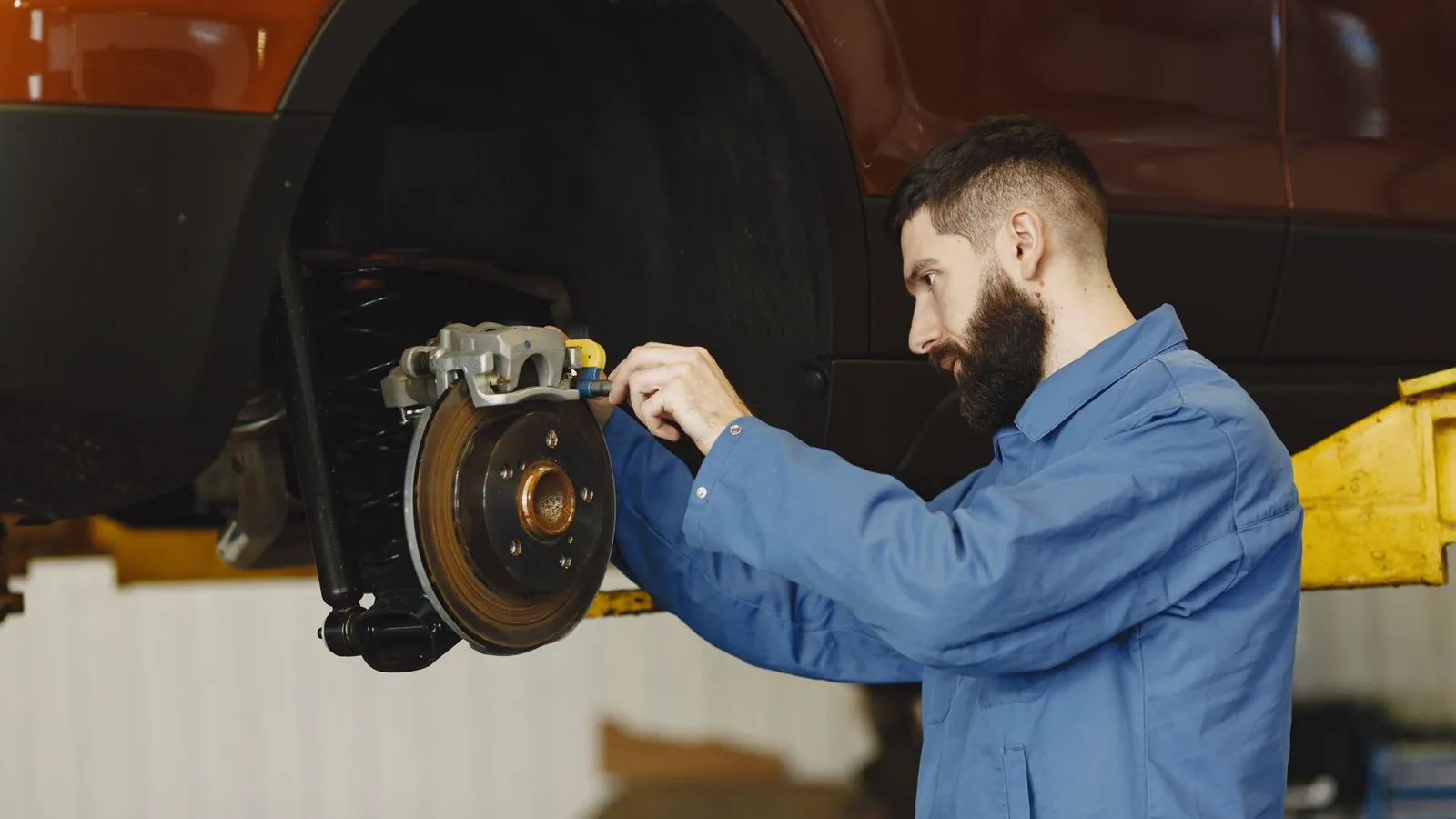 Mechanic working on a car brake system
