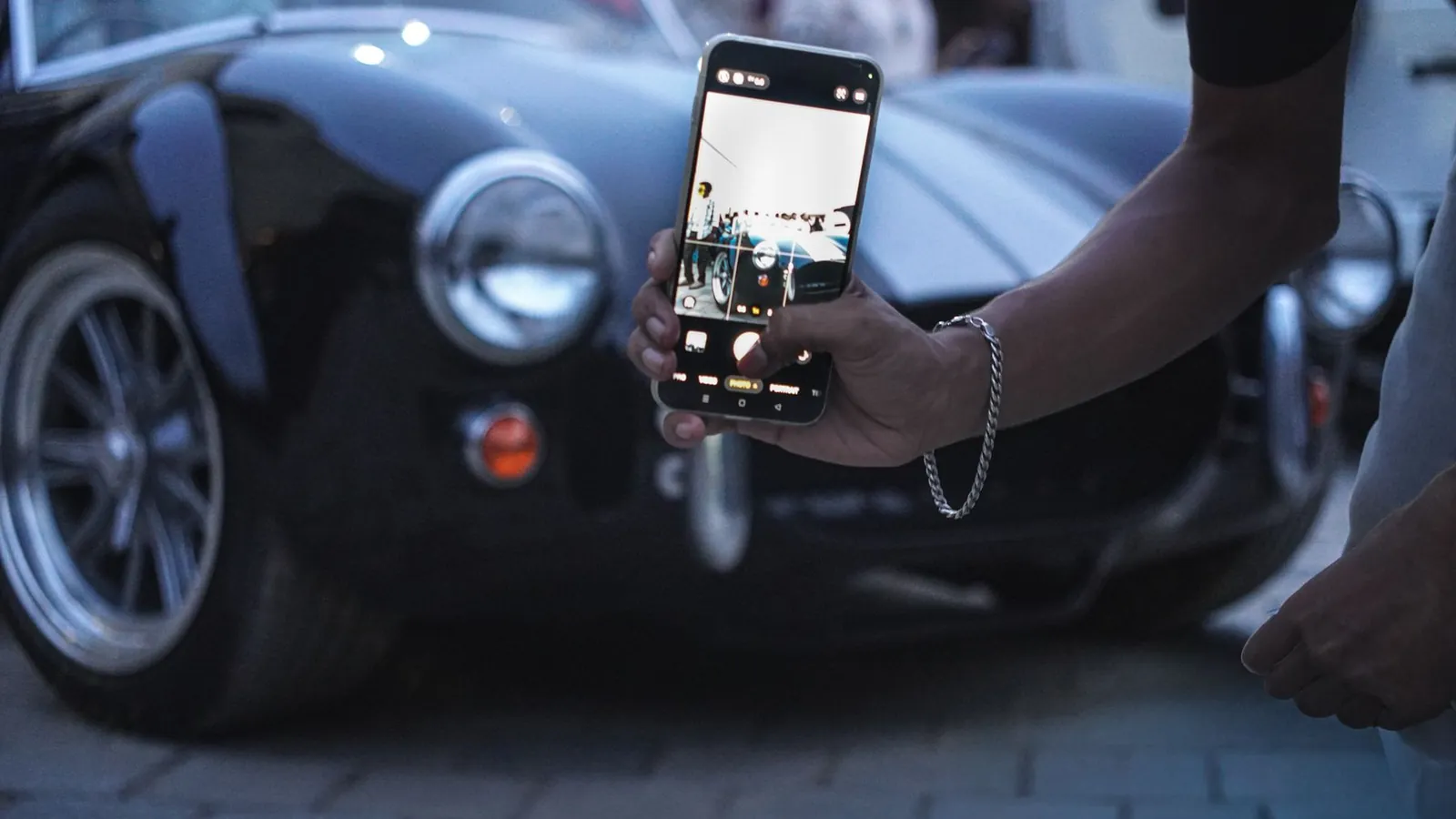 Smartphone photographing a classic car
