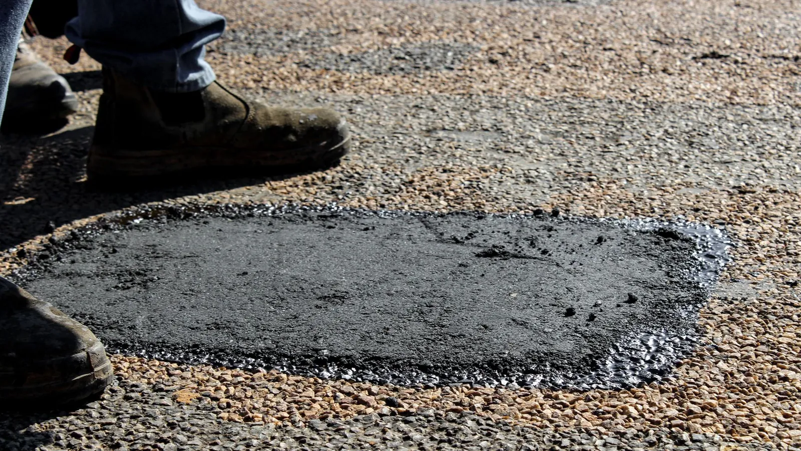 Patched pothole on a tar road