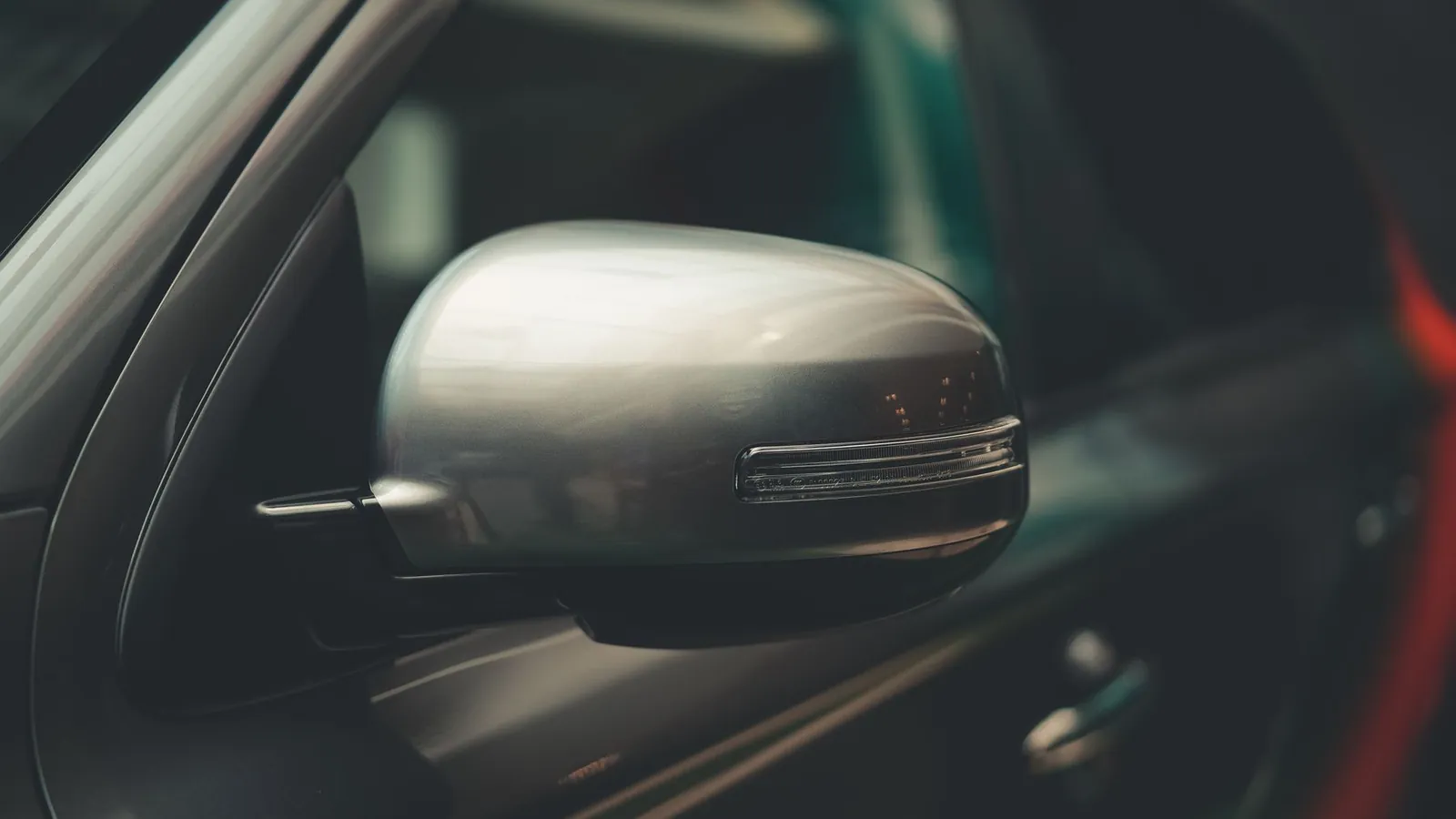 Close-up of a chrome car side mirror