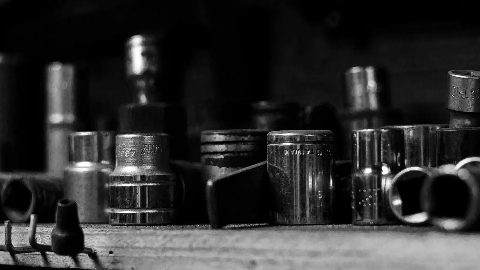 Used metal car parts and sockets on a workshop shelf