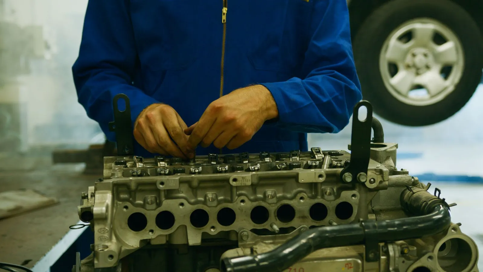 Technician inspecting an engine part